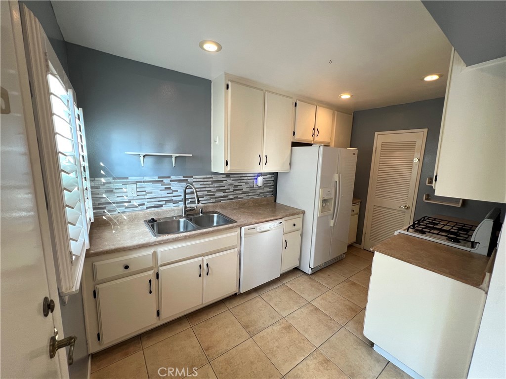 5835 Bowcroft Street, Unit 2 Los Angeles, CA 90016 - Photo 7 of 30 a kitchen with white cabinets and refrigerator