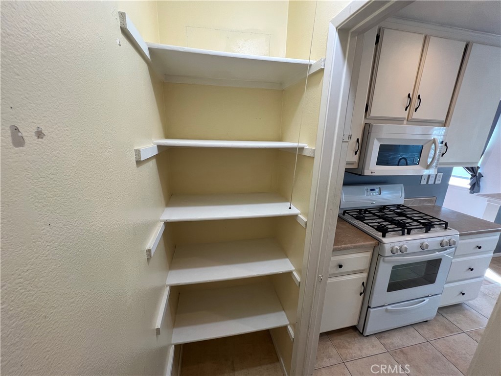 5835 Bowcroft Street, Unit 2 Los Angeles, CA 90016 - Photo 9 of 30 a kitchen with a stove and a cabinet