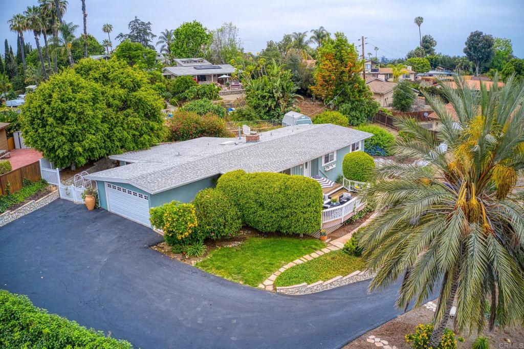 an aerial view of a house with a yard and trees