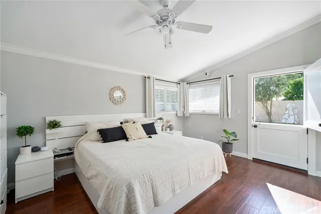 a bedroom with a large bed and a chandelier fan