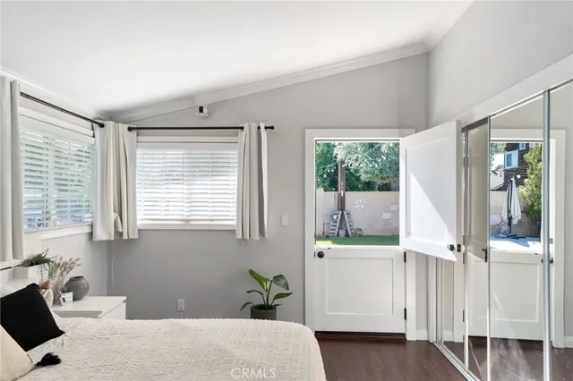 a room with a bed and large window