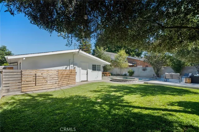 a house view with a sitting space and garden