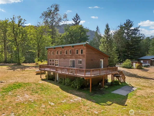 a view of a house with backyard and sitting area