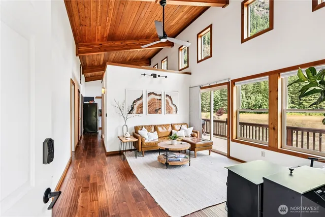 a bedroom with furniture and a large window