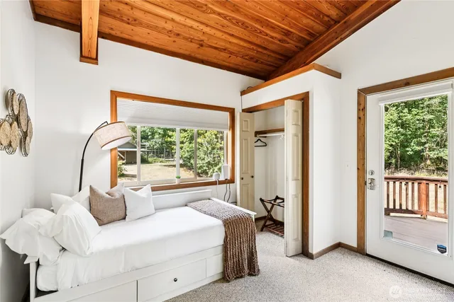 a bedroom with bed and a large window