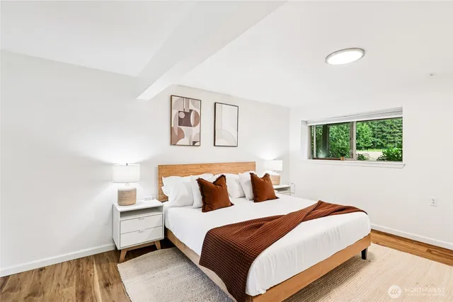 a bedroom with a bed and a window