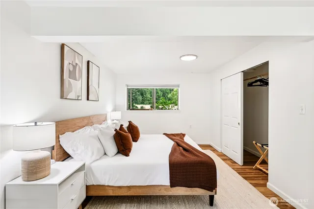 a bedroom with a bed and glass window