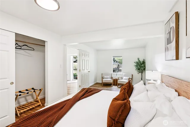 a bedroom with a bed and wooden floor