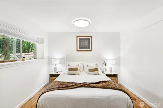 a bedroom with a large bed and a large window