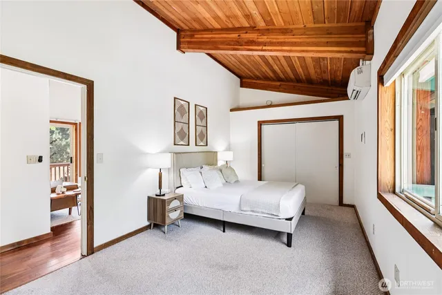 a bedroom with a bed a ceiling fan and a window