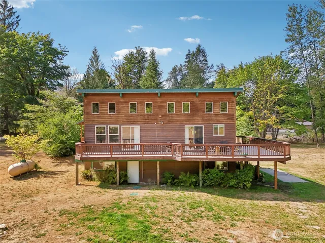 a view of a house with a yard and sitting area