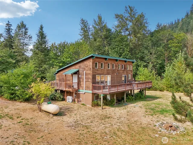 a view of a swimming pool with a patio and a yard