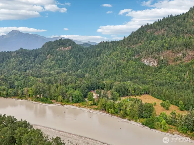 a view of a street with a houses in the background