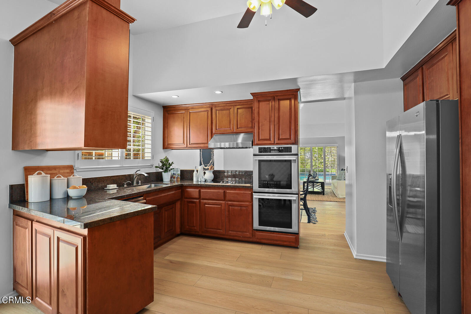 1535 Washburn Road Pasadena, CA 91105 - Photo 7 of 31 a kitchen with stainless steel appliances granite countertop a stove top oven a refrigerator a sink and dishwasher with wooden floor