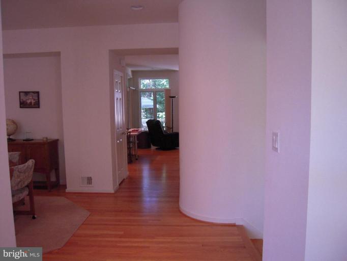 11509 Hemingway Drive Reston, VA 20194 - Photo 12 of 21 a view of a hallway with wooden floor and a livingroom