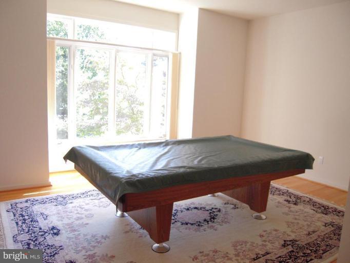 11509 Hemingway Drive Reston, VA 20194 - Photo 18 of 21 a bed sitting in a bedroom next to a window