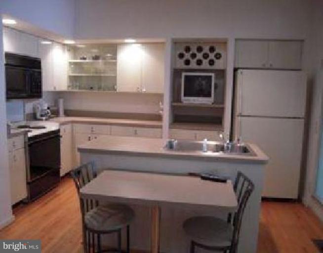 11509 Hemingway Drive Reston, VA 20194 - Photo 4 of 21 a kitchen with a sink cabinets and stainless steel appliances