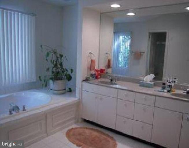 11509 Hemingway Drive Reston, VA 20194 - Photo 7 of 21 a bathroom with a granite countertop sink and a mirror