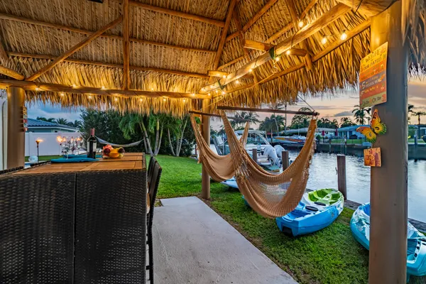 a view of swimming pool with lounge chairs in patio