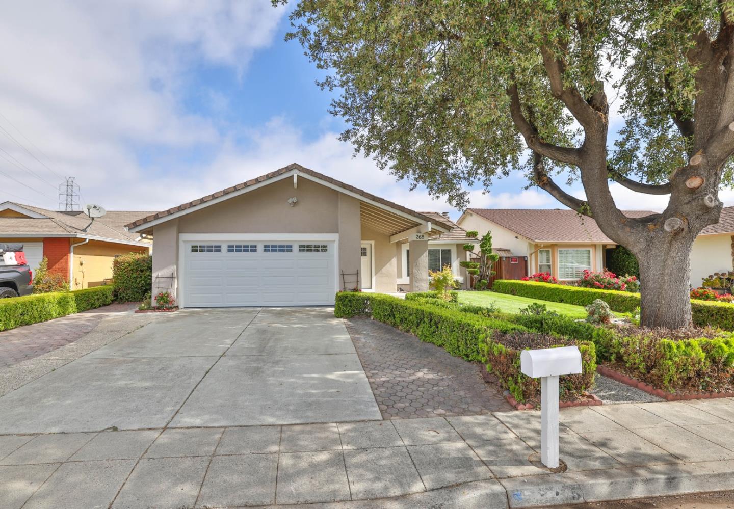 a view of a house with a yard and large trees
