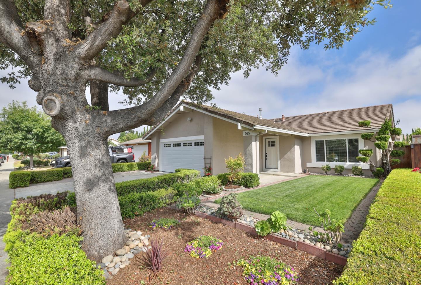 365 San Andreas Drive Milpitas, CA 95035 - Photo 2 of 26 a front view of a house with a yard and potted plants
