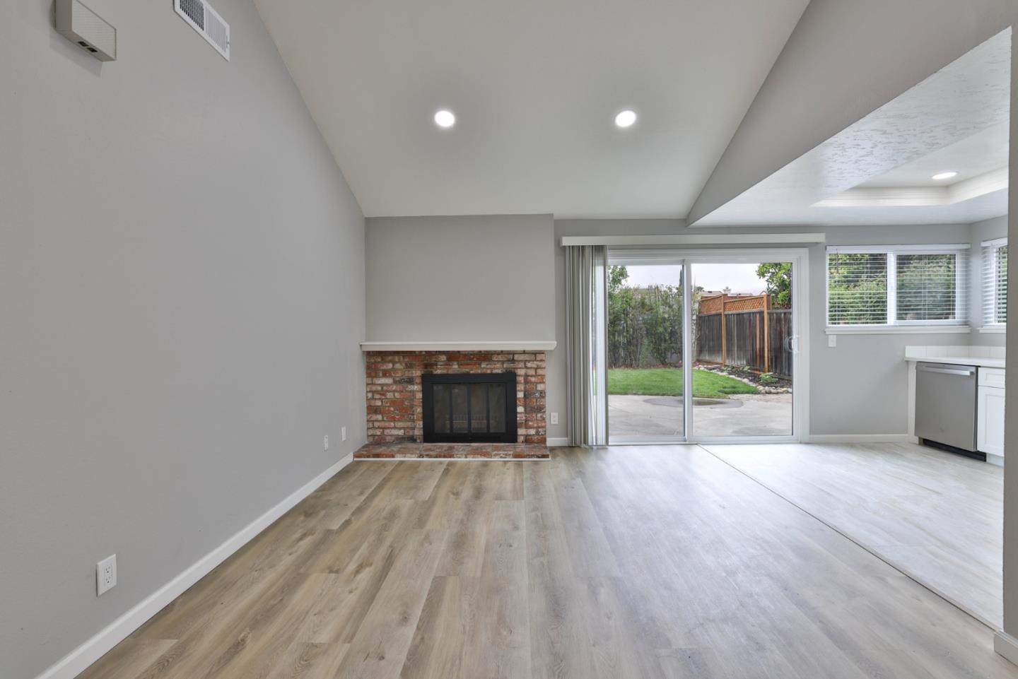 365 San Andreas Drive Milpitas, CA 95035 - Photo 6 of 26 a view of an empty room with a fireplace and a window