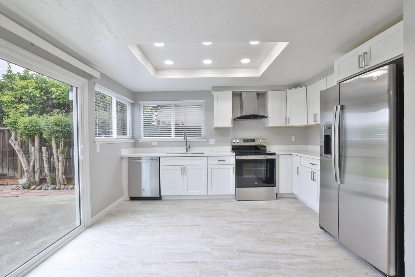 365 San Andreas Drive Milpitas, CA 95035 - Photo 9 of 26 a kitchen with a refrigerator sink and cabinets