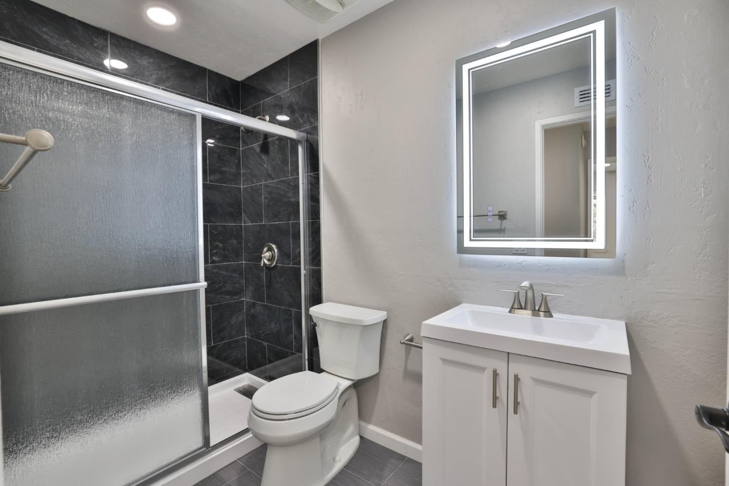 365 San Andreas Drive Milpitas, CA 95035 - Photo 10 of 26 a bathroom with a toilet a sink and shower