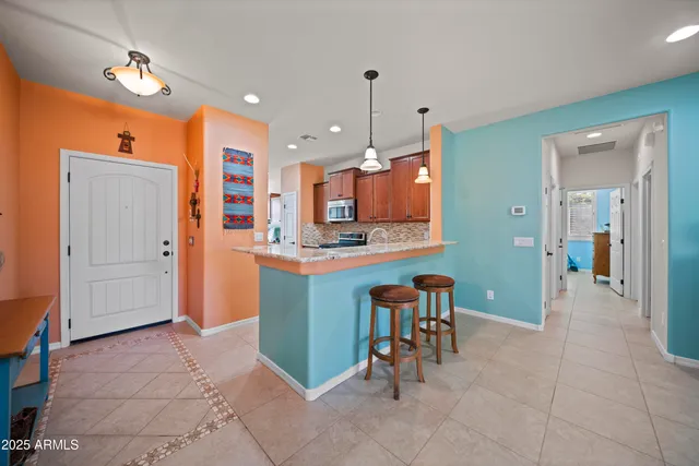 a view of kitchen with kitchen island dining table and chairs