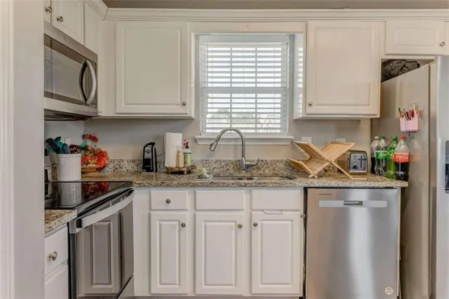 a kitchen with stainless steel appliances granite countertop cabinets and a counter top space