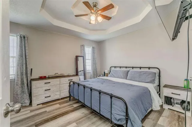 a bedroom with a bed and a chandelier