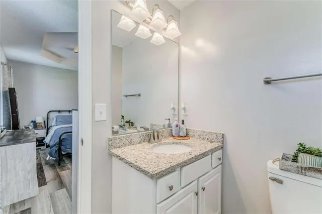 a bathroom with a sink vanity granite and a mirror