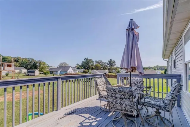 a view of a house with a patio and a yard