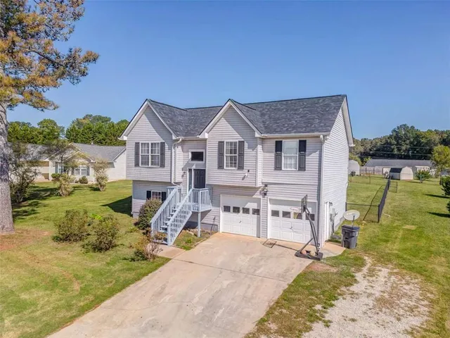 a front view of a house with a yard table and chairs