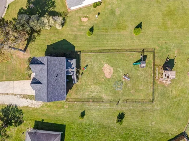 an aerial view of a city with lots of residential buildings and mountain view in back