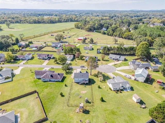 an aerial view of residential houses with outdoor space