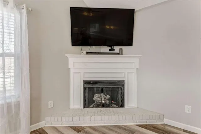 a living room with a fireplace and a flat screen tv