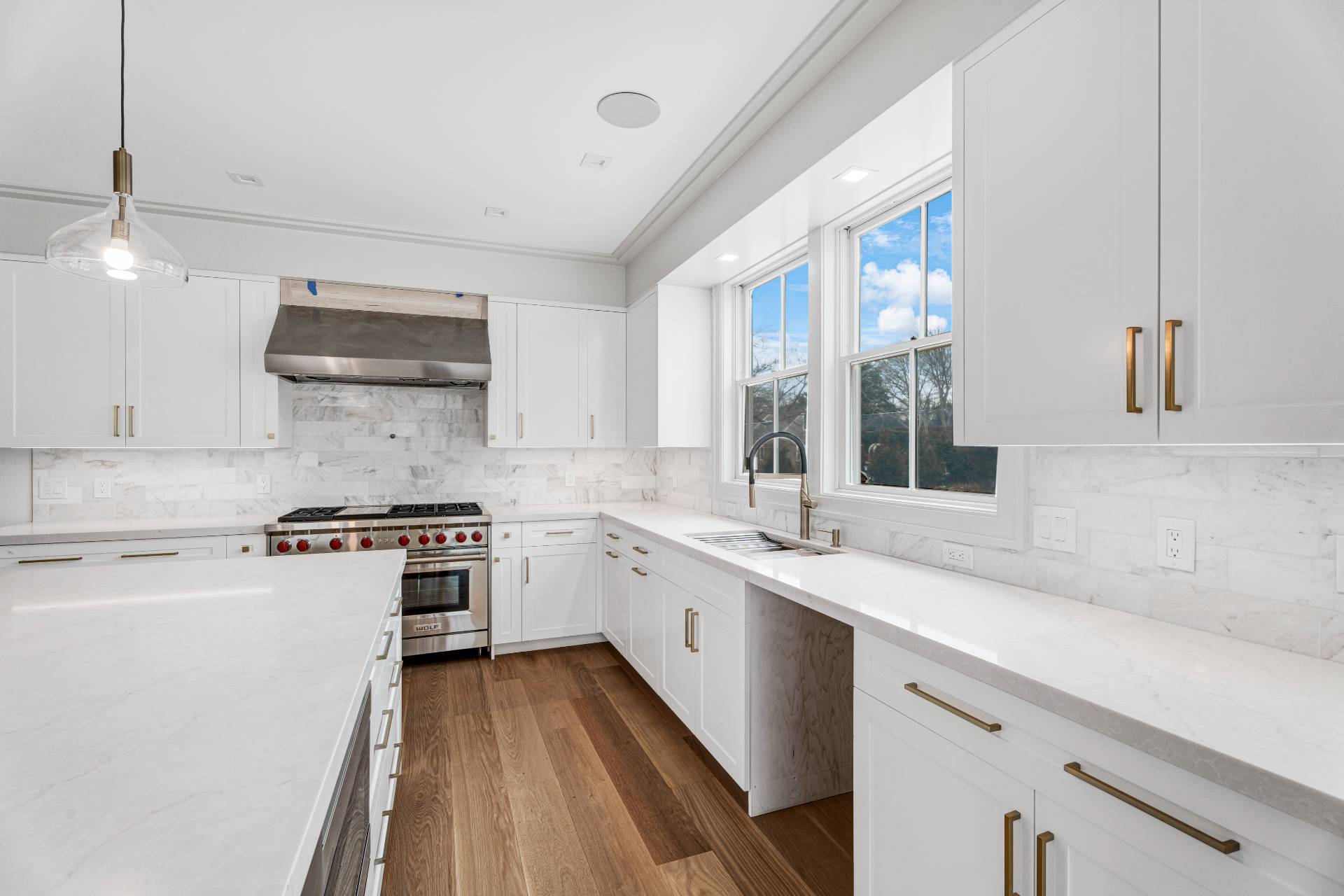 93 South Country Road Remsenburg, NY 11960 - Photo 5 of 27 a kitchen with a sink stove and cabinets