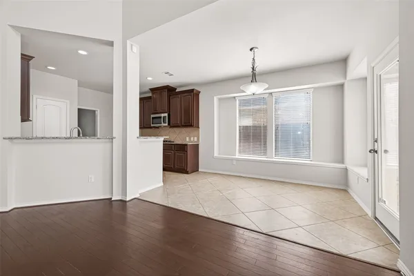an empty room with kitchen and a window