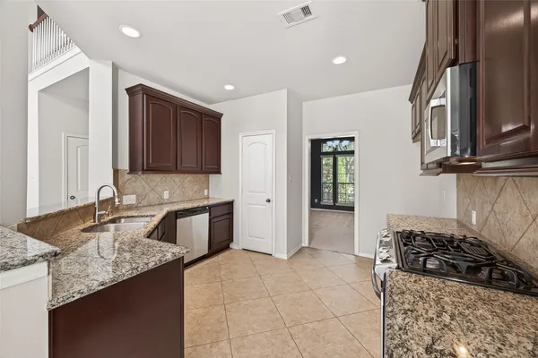 a kitchen with a stove and a sink