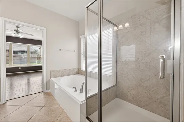 a bathroom with a bathtub and a shower