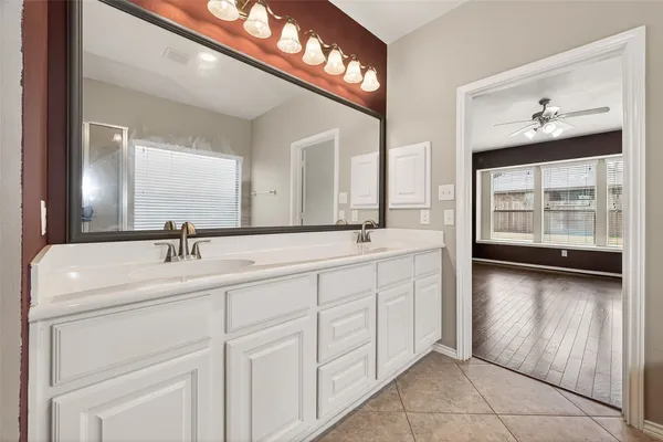 a bathroom with a double vanity sink and a mirror