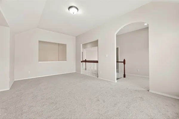 an empty room with a cabinet and mirrors