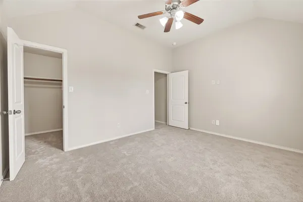 an empty room with a empty space and a ceiling fan