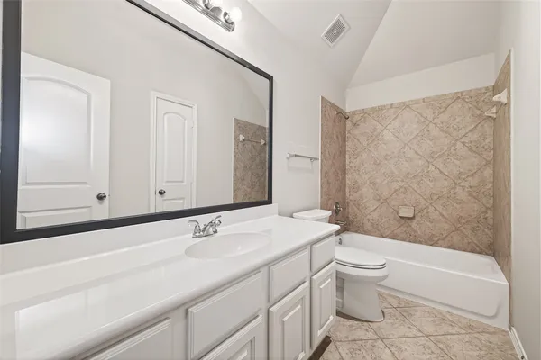 a bathroom with a sink a toilet and bathtub