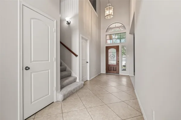 an empty room that has a large mirror with front door