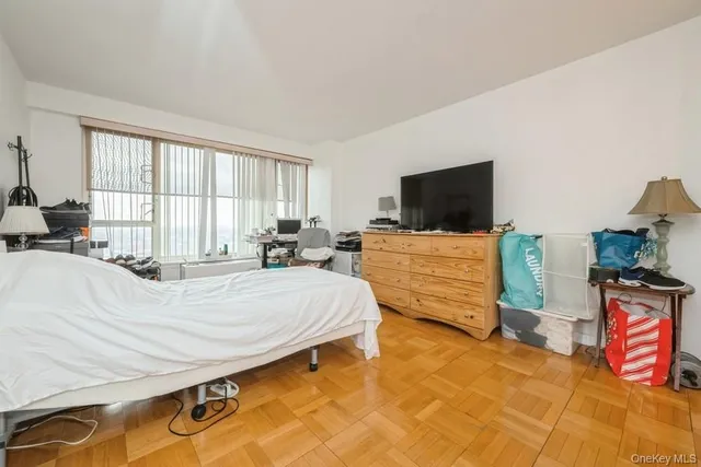 a bed room with a bed and flat tv screen