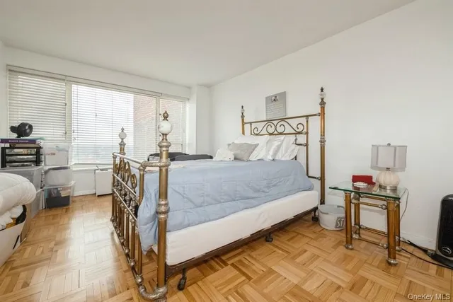 a bed room with a bed and a chair