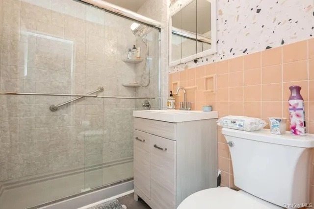 a bathroom with a sink toilet and shower