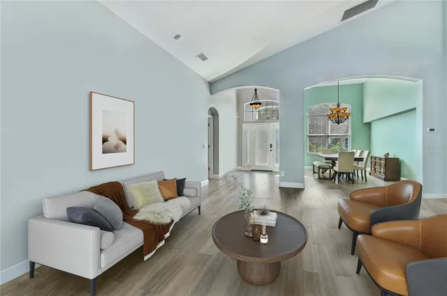 a living room with furniture and wooden floor